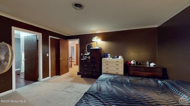 bedroom with carpet, visible vents, crown molding, and baseboards