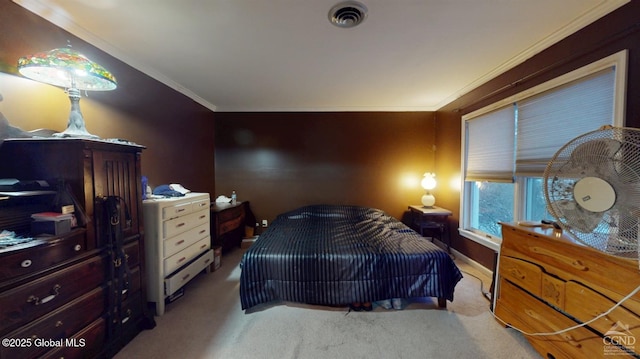 carpeted bedroom with visible vents and crown molding