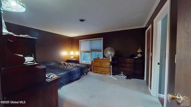 carpeted bedroom featuring visible vents and crown molding