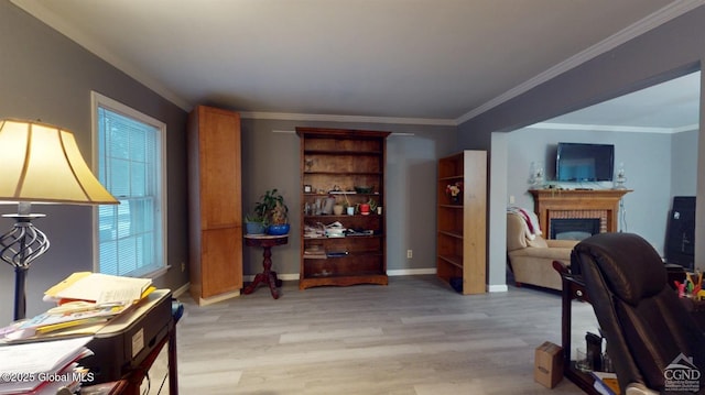 interior space with baseboards, light wood-type flooring, a fireplace, and crown molding