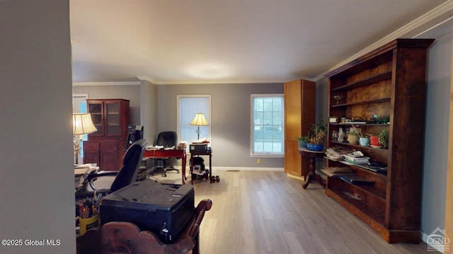 office area with crown molding, wood finished floors, and baseboards