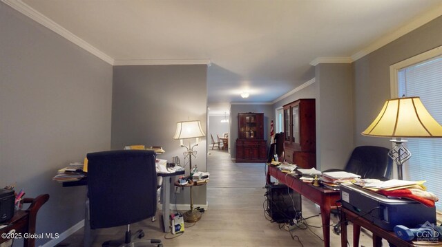 office area featuring baseboards, ornamental molding, and wood finished floors