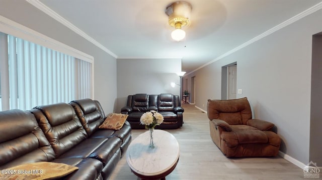 living area featuring crown molding, ceiling fan, light wood-style flooring, and baseboards