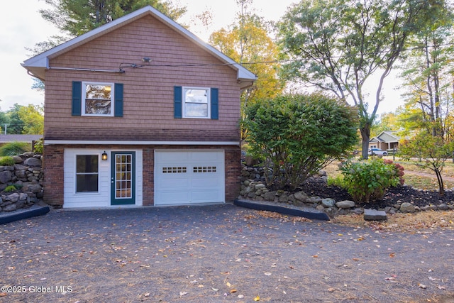 view of front of property featuring a garage and aphalt driveway