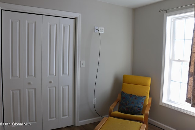 living area with a wealth of natural light and baseboards