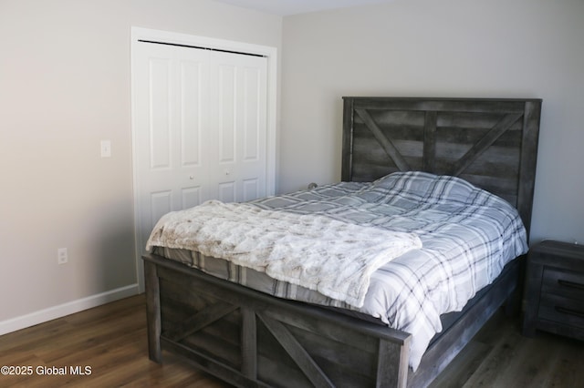 bedroom featuring a closet, baseboards, and dark wood-type flooring