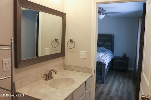 bathroom with vanity, wood finished floors, and a ceiling fan