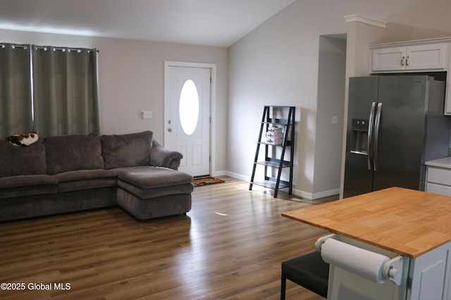 living area featuring baseboards, dark wood-type flooring, and lofted ceiling