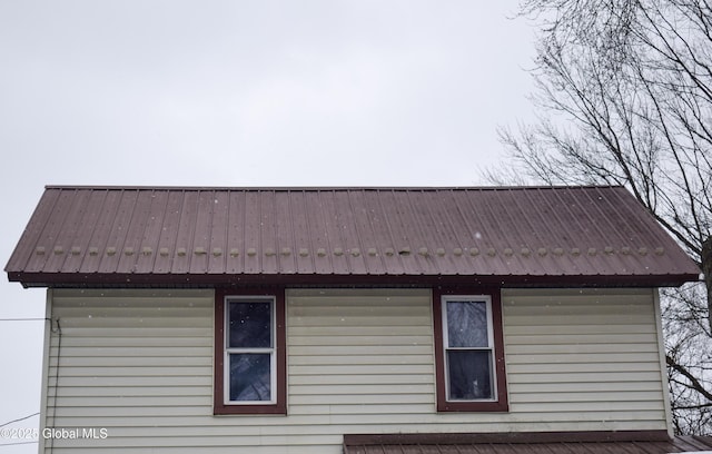 view of side of property with metal roof