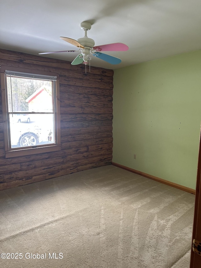 empty room featuring a ceiling fan, baseboards, and carpet flooring