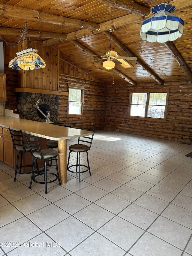 dining room with rustic walls, light tile patterned floors, lofted ceiling with beams, wooden ceiling, and ceiling fan