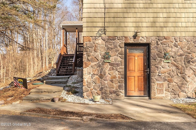 property entrance with stone siding