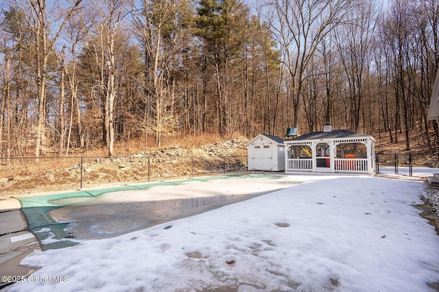 exterior space with a gazebo, a shed, an outbuilding, and fence