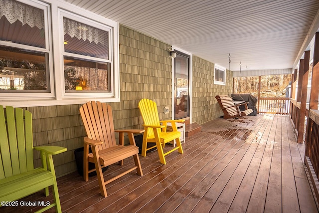 wooden terrace with a porch and a grill