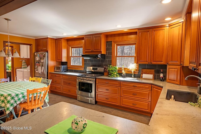 kitchen with plenty of natural light, separate washer and dryer, stainless steel appliances, and a sink