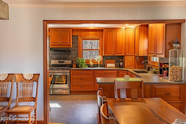 kitchen with ornamental molding, a sink, gas stove, brown cabinetry, and decorative backsplash