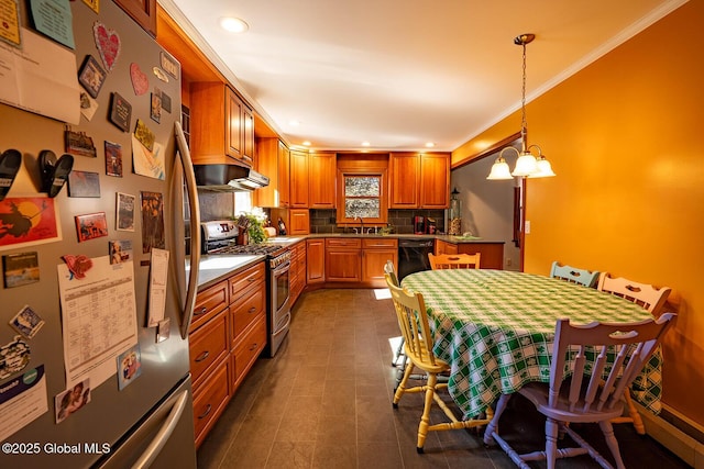 kitchen featuring under cabinet range hood, ornamental molding, decorative backsplash, stainless steel appliances, and a sink