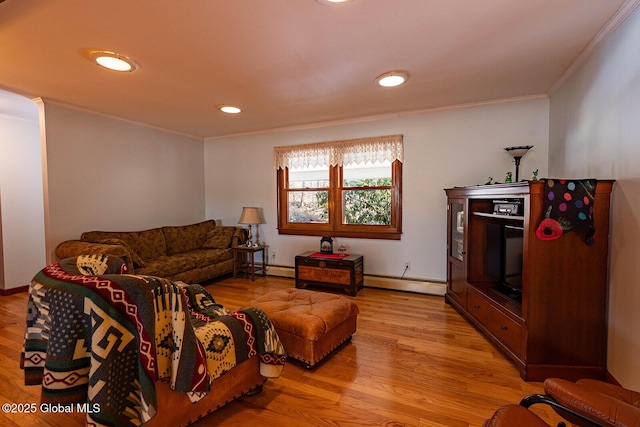 living room featuring baseboards, light wood-style floors, baseboard heating, and crown molding