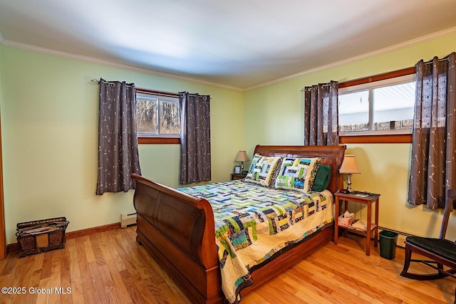 bedroom with ornamental molding, wood finished floors, baseboards, and a baseboard radiator