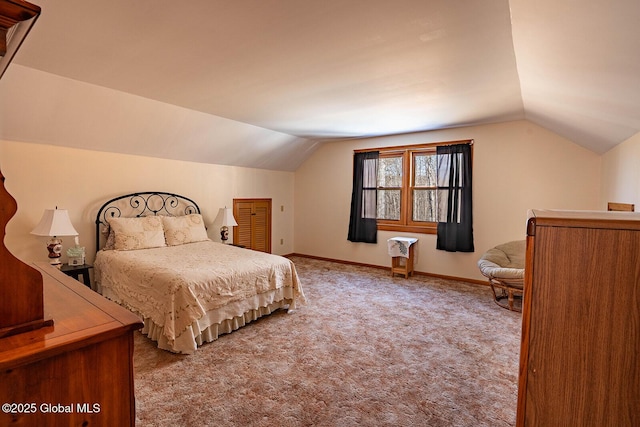 carpeted bedroom featuring baseboards and lofted ceiling