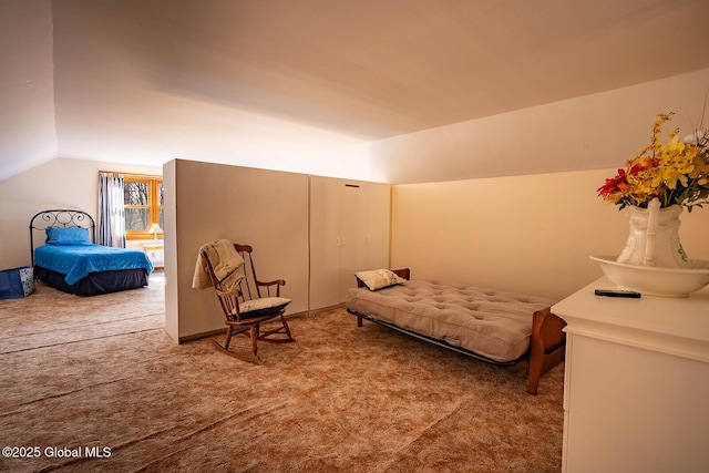 bedroom with vaulted ceiling and carpet