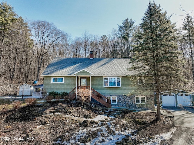 view of front of property featuring a garage and a chimney