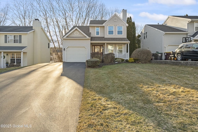 traditional-style home with driveway, a porch, roof with shingles, an attached garage, and a front yard