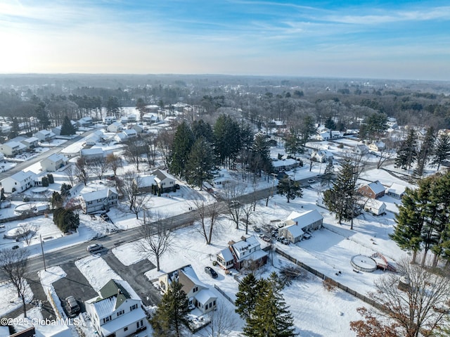 snowy aerial view with a residential view