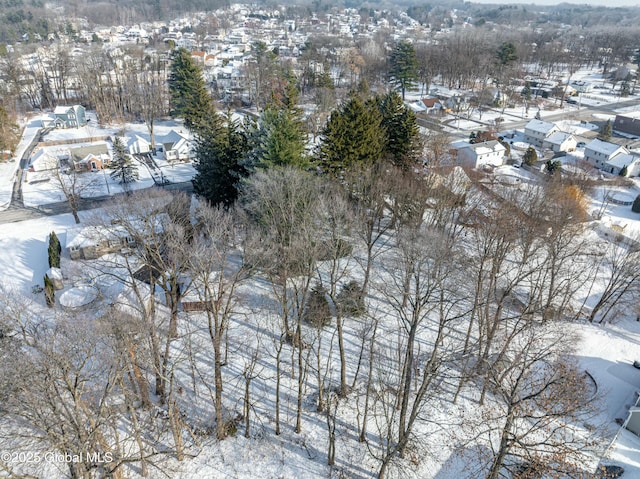 snowy aerial view featuring a residential view