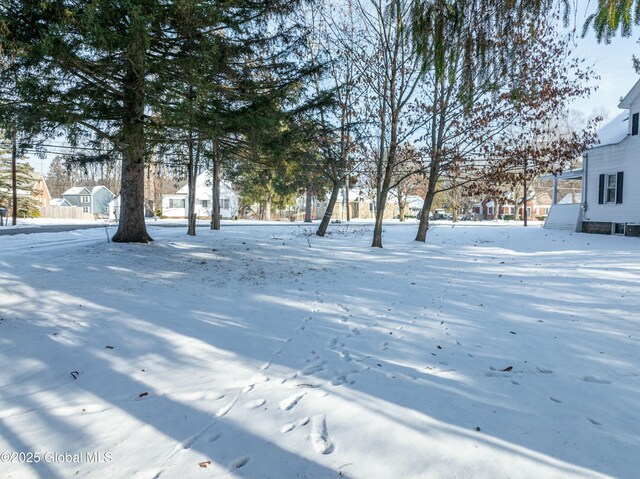 snowy yard with a residential view