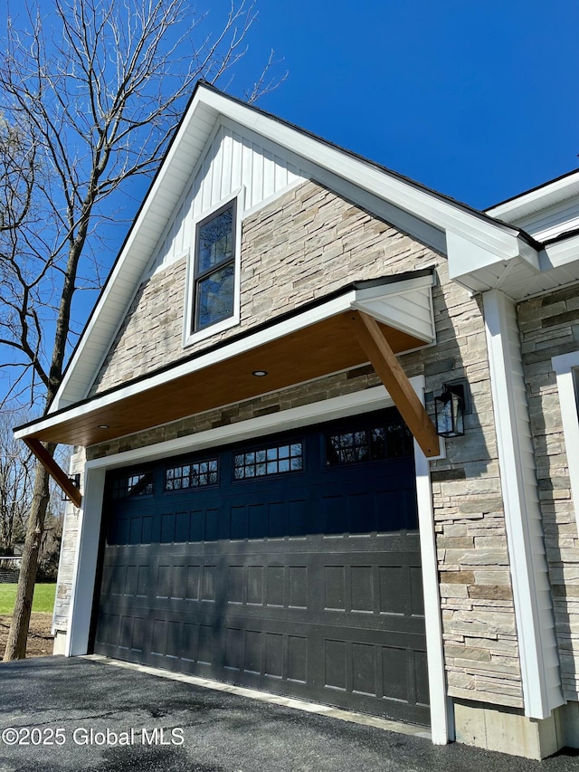 view of property exterior featuring board and batten siding and a garage