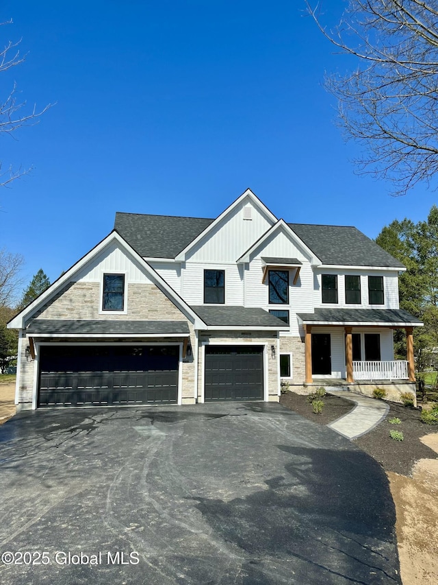 modern farmhouse style home with a porch, driveway, a shingled roof, and an attached garage