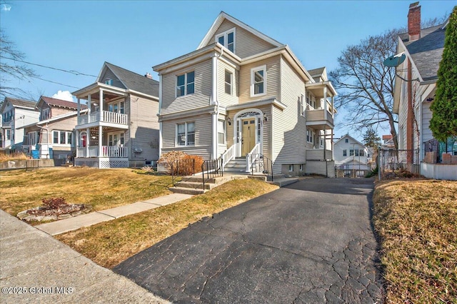 view of front of home featuring a residential view and a balcony