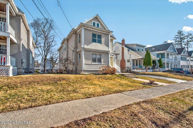 view of front of property featuring a residential view and a front lawn