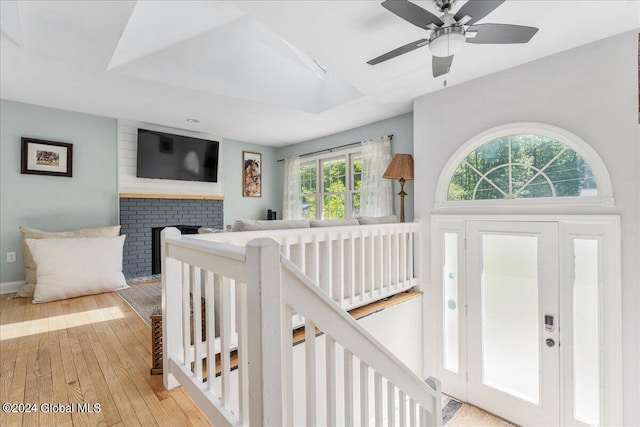 foyer featuring wood-type flooring, a fireplace, and baseboards