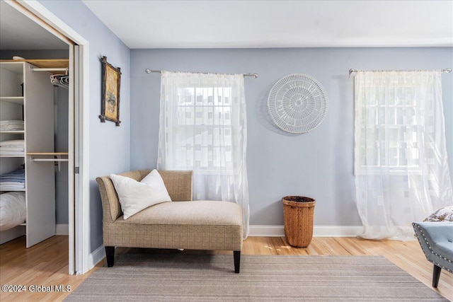 living area featuring baseboards and wood finished floors