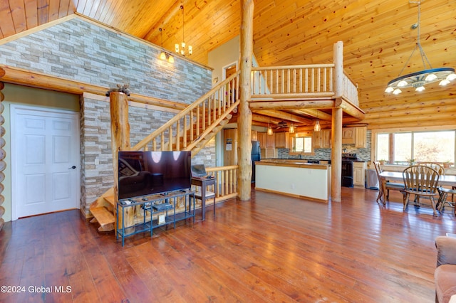 living area with high vaulted ceiling, wood ceiling, wood finished floors, and stairs