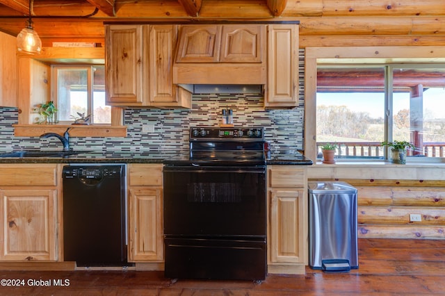 kitchen featuring decorative backsplash, black appliances, premium range hood, and light brown cabinetry