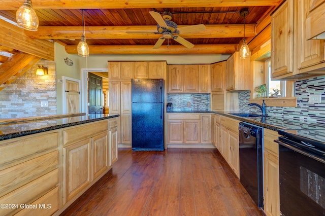 kitchen with a sink, decorative backsplash, black appliances, and dark wood-style floors