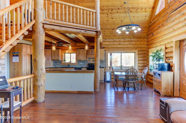 kitchen with electric range, backsplash, high vaulted ceiling, and dark wood-style flooring