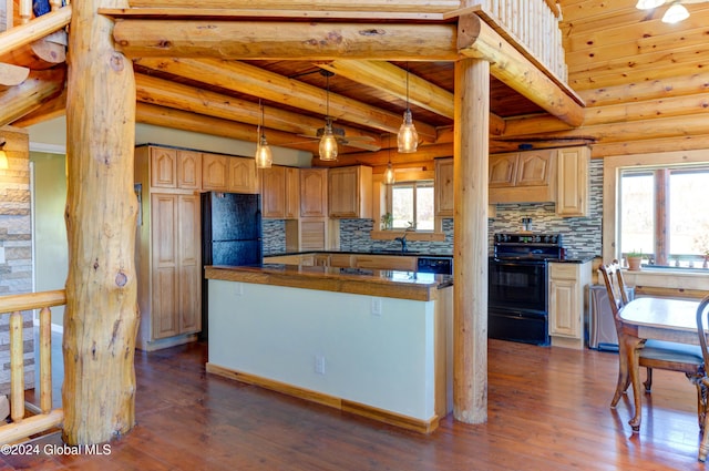 kitchen featuring dark wood finished floors, black appliances, dark countertops, and log walls