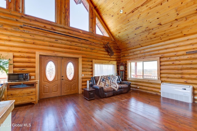 unfurnished living room with hardwood / wood-style floors, high vaulted ceiling, wood ceiling, and log walls