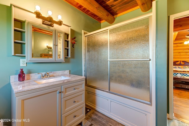 bathroom with bath / shower combo with glass door, wood ceiling, beam ceiling, wood finished floors, and vanity