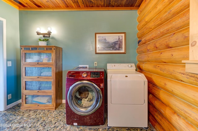 washroom featuring washer and clothes dryer, rustic walls, wooden ceiling, baseboards, and laundry area