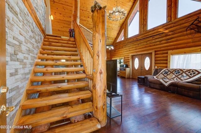 staircase with high vaulted ceiling, log walls, hardwood / wood-style flooring, wooden ceiling, and a chandelier