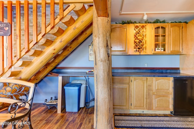 kitchen with glass insert cabinets, refrigerator, and wood finished floors