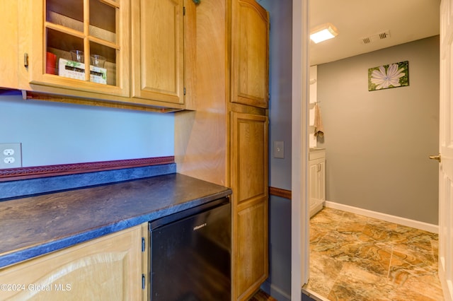 kitchen featuring visible vents, baseboards, dark countertops, and refrigerator