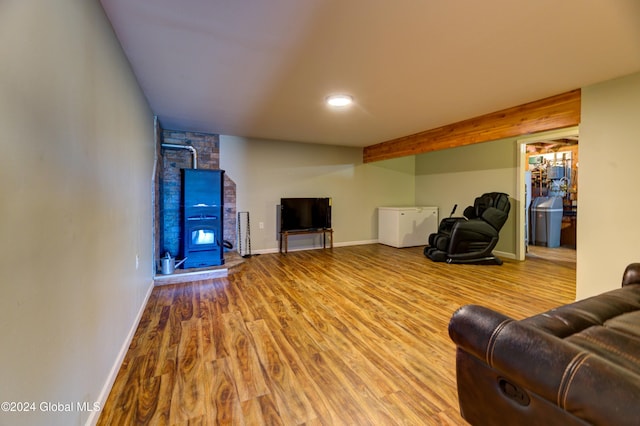 living area featuring baseboards and wood finished floors