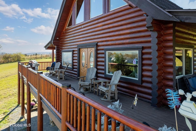 wooden deck featuring a grill