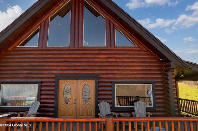 entrance to property featuring log siding